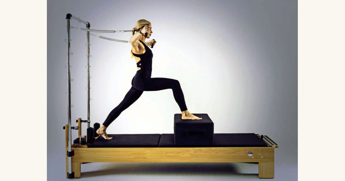 Illustration of a person performing the classic pilates Hundred exercise on a reformer, warm brown and gold palette.